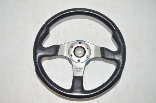 Momo Universal Aftermarket Subaru Racing Steering Wheel with blue spacers.